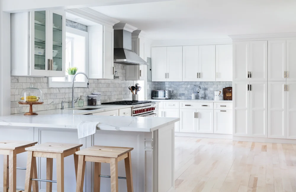 Fabuwood cabinetry — classic white kitchen with wood stools