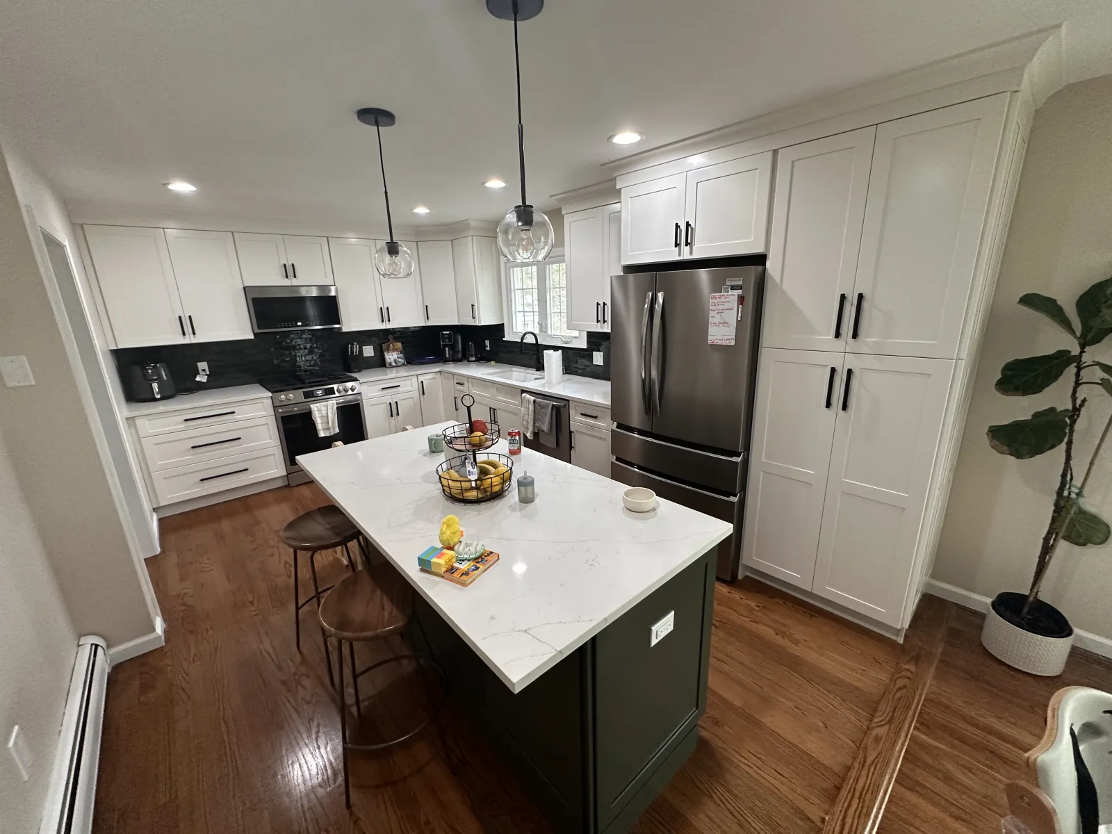 White and navy open-plan kitchen with quartz island