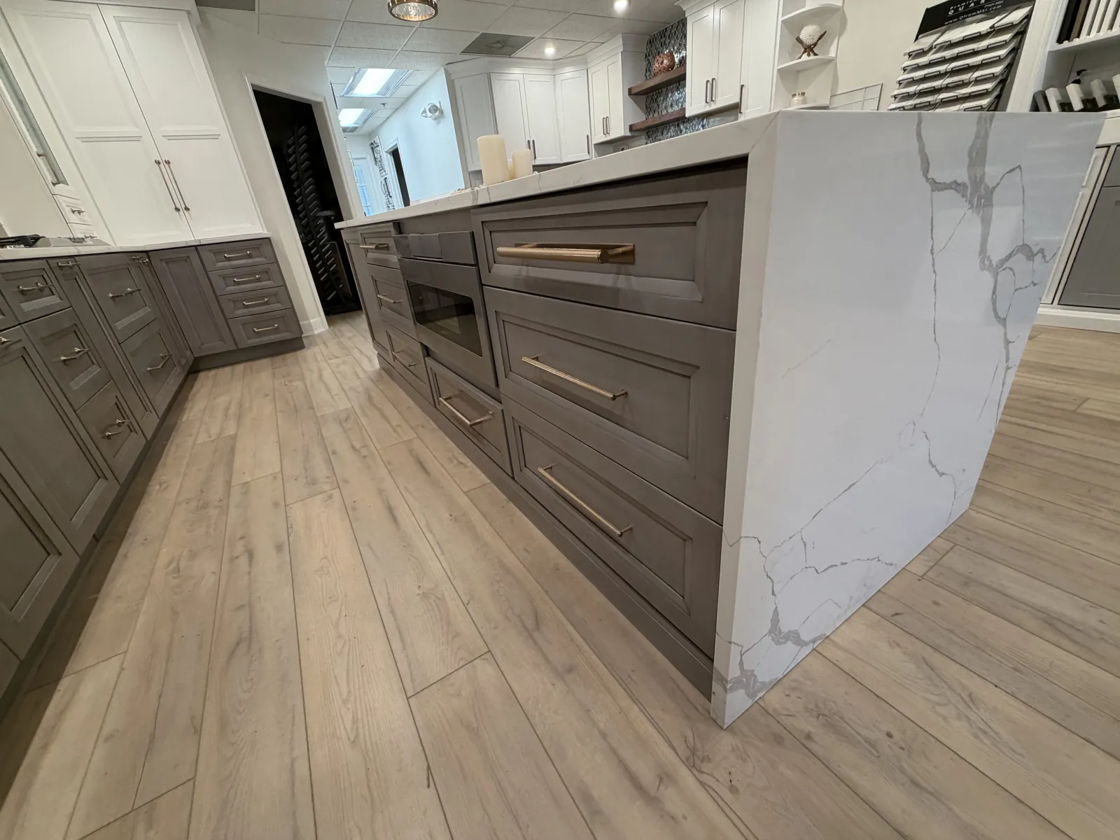 Grey kitchen with a marble waterfall island