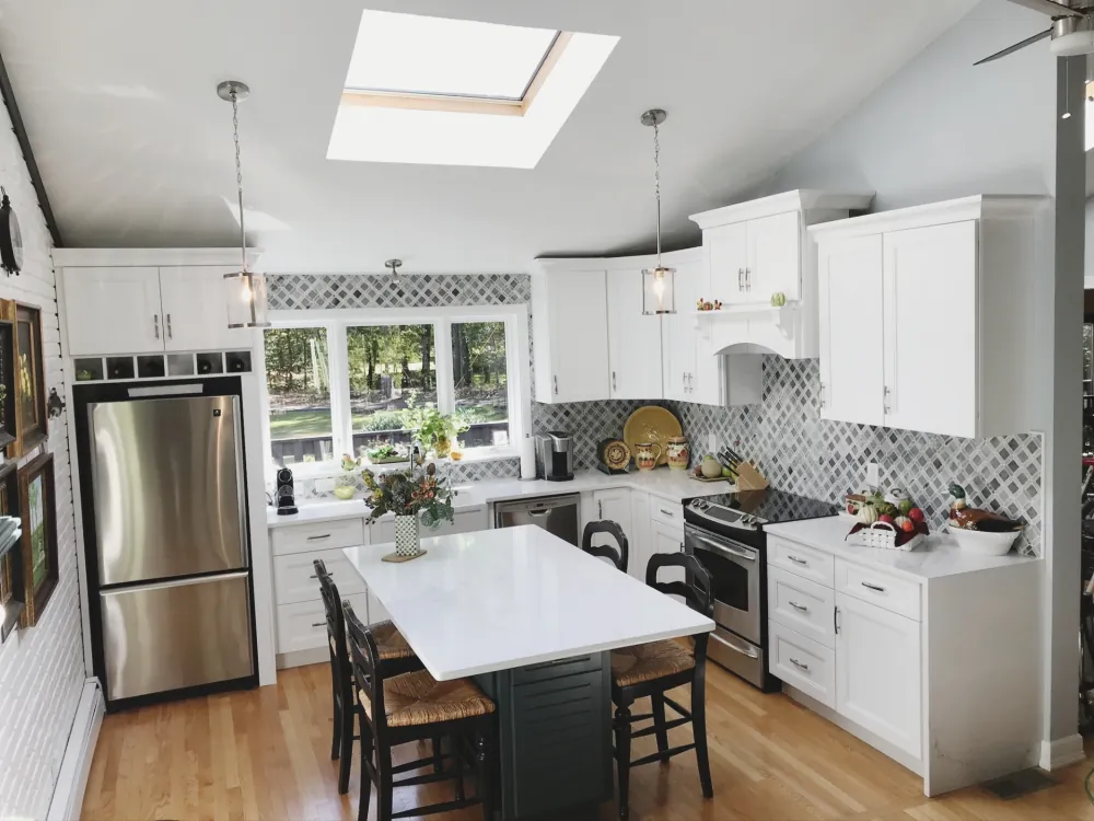 Bright white kitchen with skylights and patterned backsplash