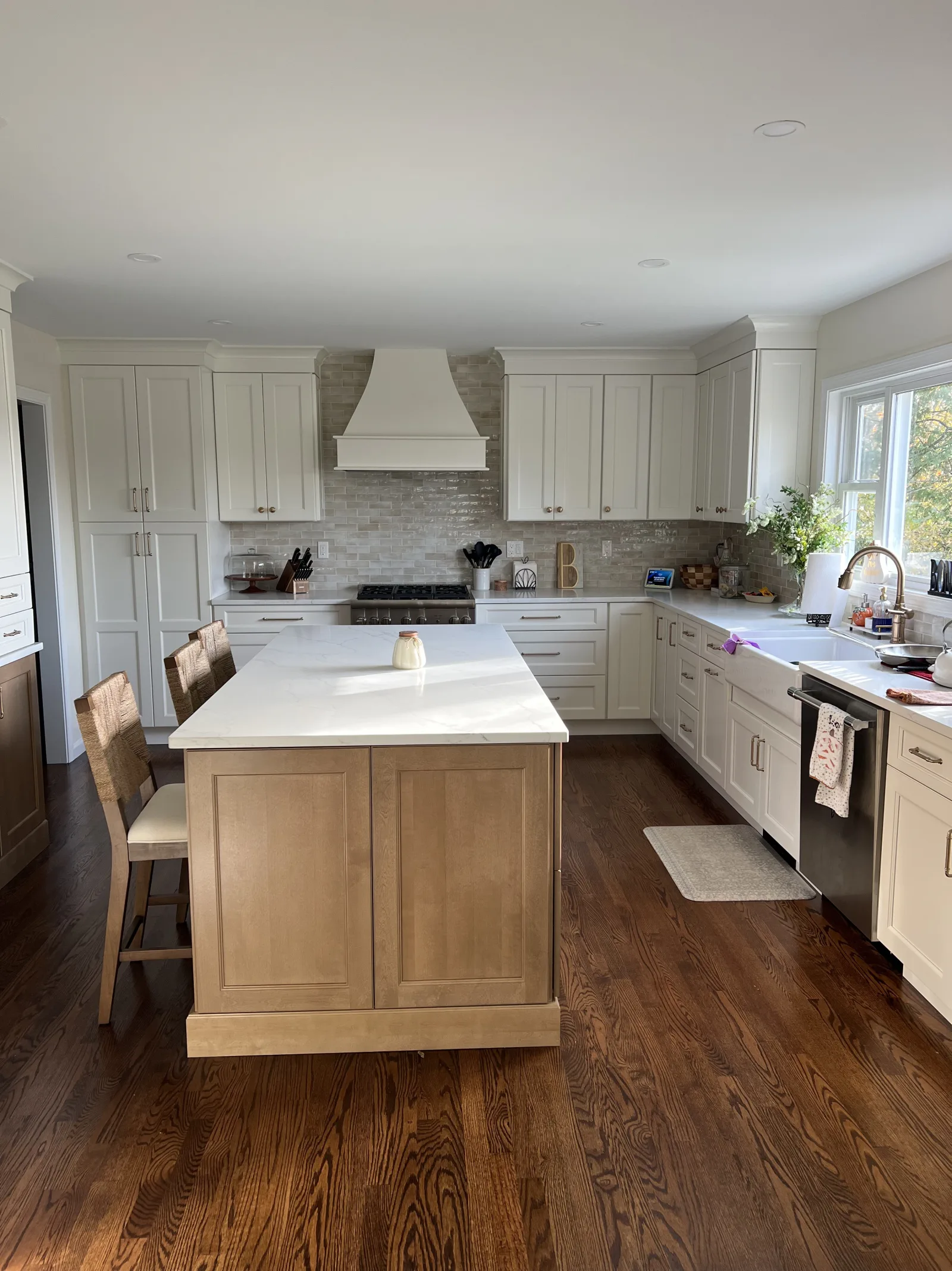 White shaker kitchen with a natural wood island